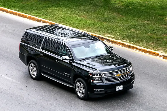 An aerial view of a Chevrolet Suburban driving on the road