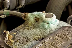 Green corrosion covering a car battery terminal