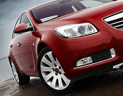 The front end of a cherry red Opel Insignia